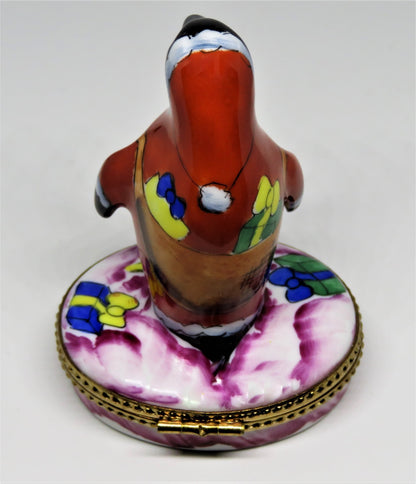 LIMOGES BOX- CHRISTMAS - WHIMSICAL PENGUIN IN A SANTA CLAUS SUIT - SACK OF GIFTS